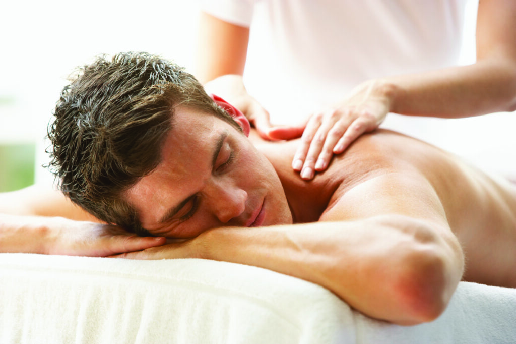 Young Man Enjoying Massage At Spa